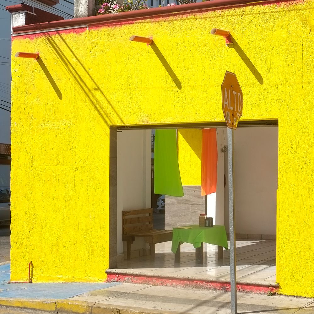 Playa del Carmen, Mexico. Bight yellow cafe on the street.